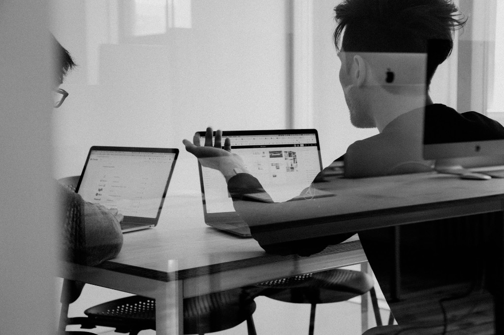 Investors reviewing company search and sourcing workflows on laptops
